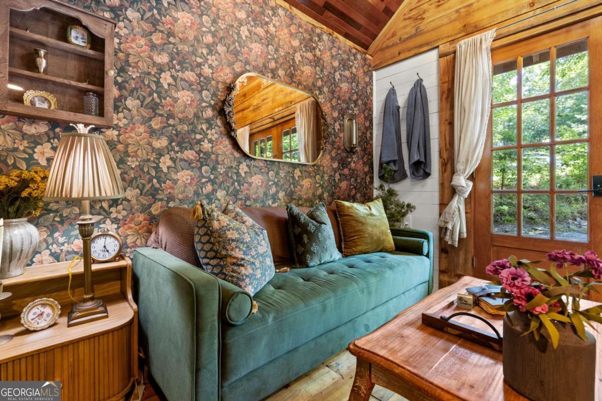 120 Community Hill Drive Blue Ridge, GA 30513 - Photo 33 of 57 a living room with furniture and a floor to ceiling window