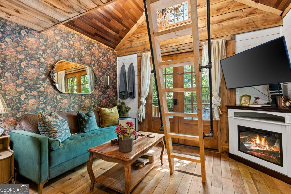 120 Community Hill Drive Blue Ridge, GA 30513 - Photo 35 of 57 a living room with furniture a flat screen tv and a fireplace