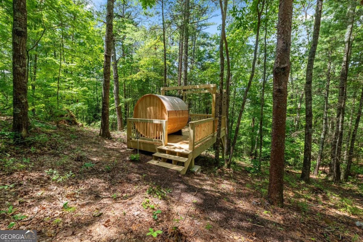 120 Community Hill Drive Blue Ridge, GA 30513 - Photo 50 of 57 a backyard of a house with childrens swing and outdoor seating