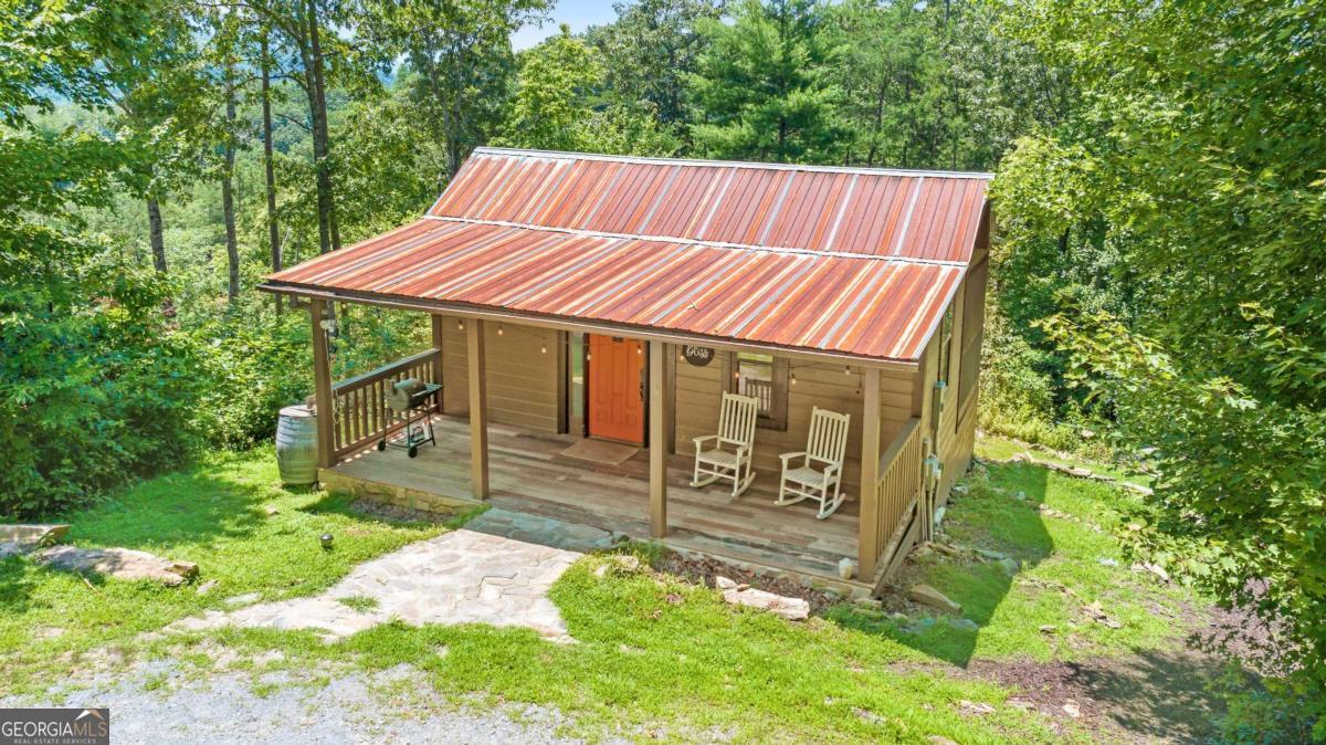 120 Community Hill Drive Blue Ridge, GA 30513 - Photo 8 of 57 a view of a house with a yard and sitting area