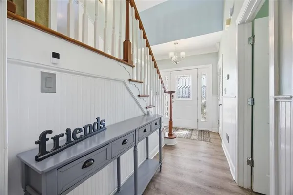 a view of entryway and hall with wooden floor