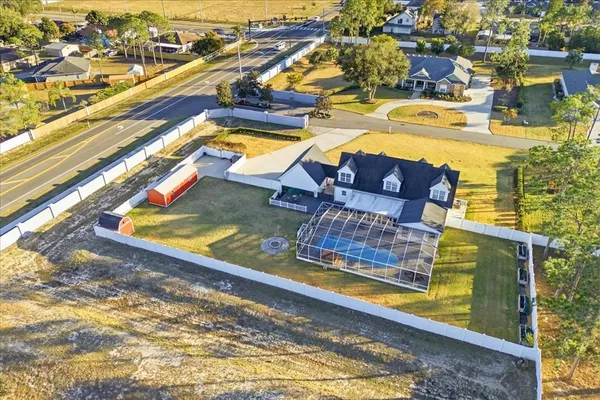 a swimming pool with outdoor seating and yard