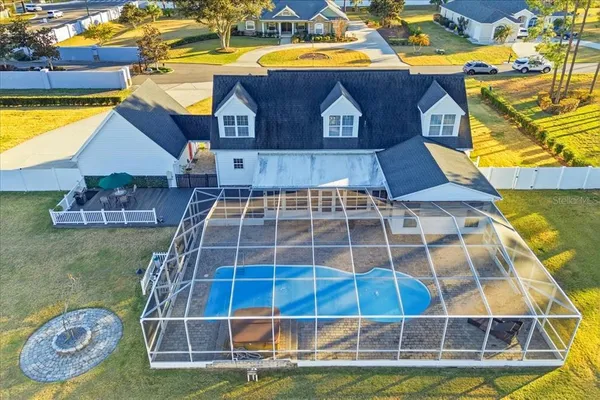 a view of a house with swimming pool and sitting area