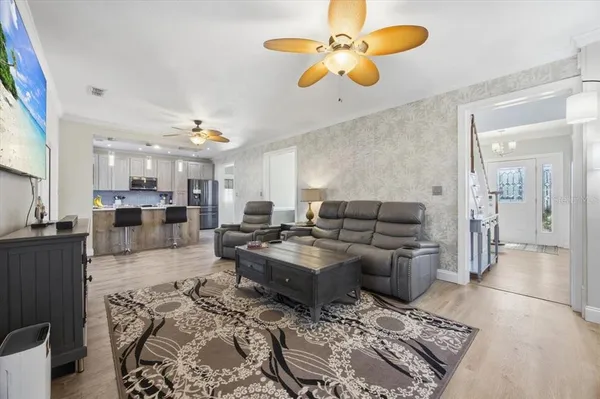 a kitchen with stainless steel appliances granite countertop a stove a sink and a microwave