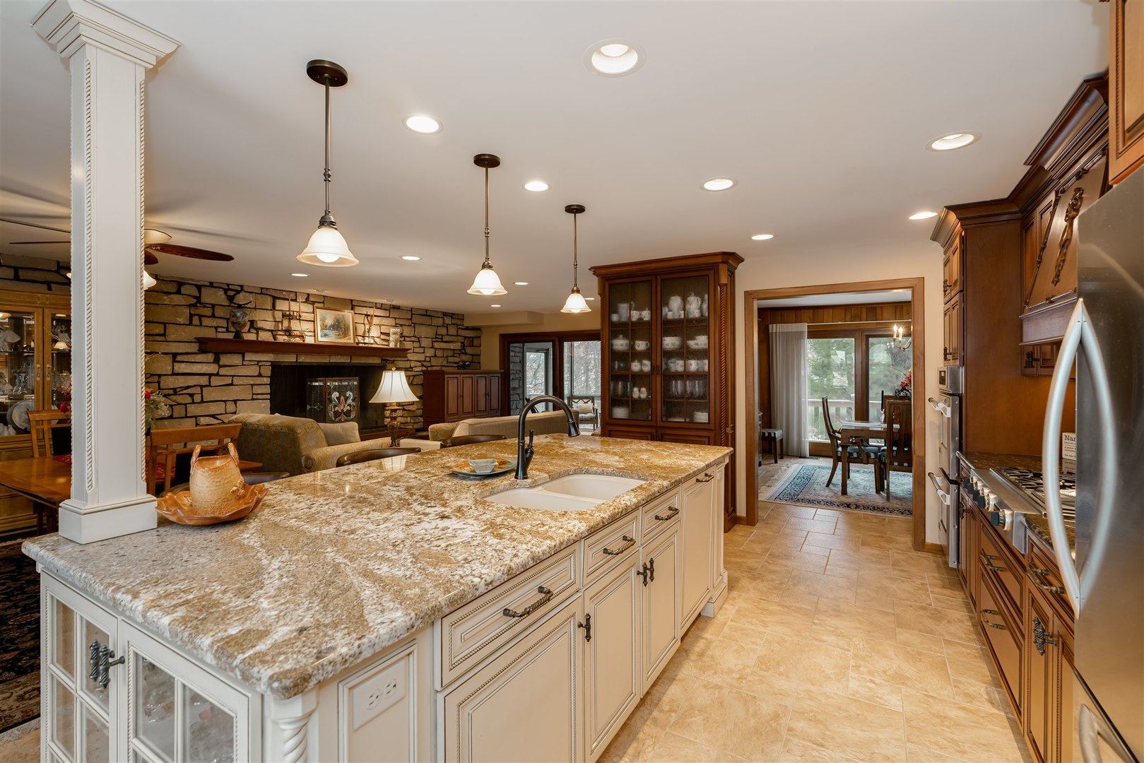 219 Parkview Drive Bloomington, IL 61701 - Photo 16 of 60 a large kitchen with kitchen island a large counter top space a sink stainless steel appliances and cabinets