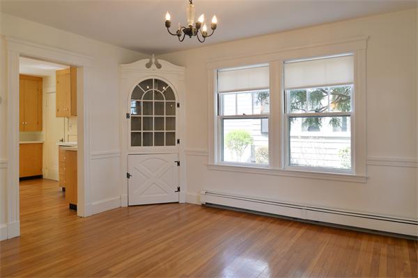 6 Lindbergh Road Marblehead, MA 01945 - Photo 2 of 9 an empty room with wooden floor chandelier and windows