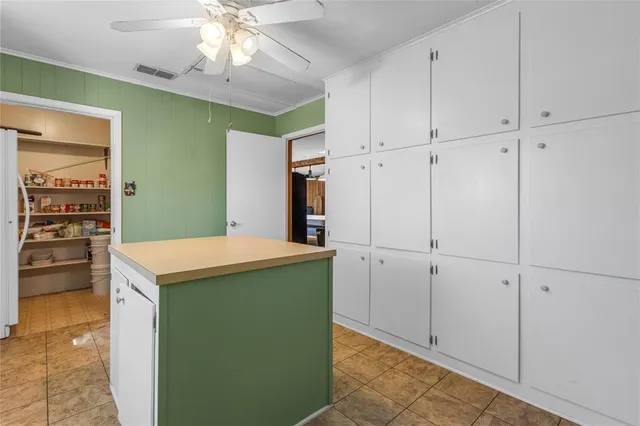 a utility room with cabinets washer and dryer