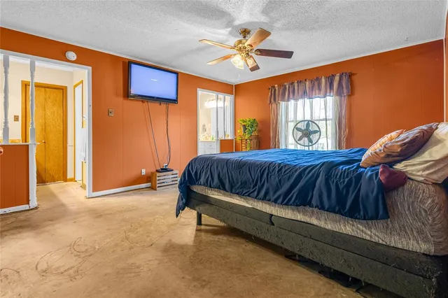 a bedroom with a bed and window