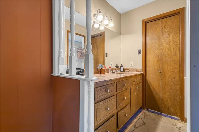 a bathroom with a double vanity sink and a mirror