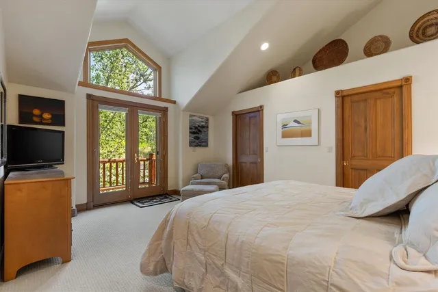 a bedroom with a bed and a large window