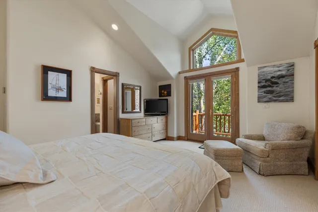 a bedroom with a large bed and a couch