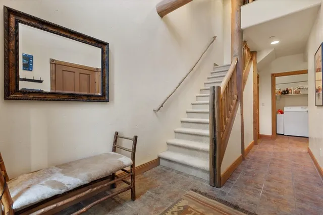 a view of hallway with stairs and wooden floor