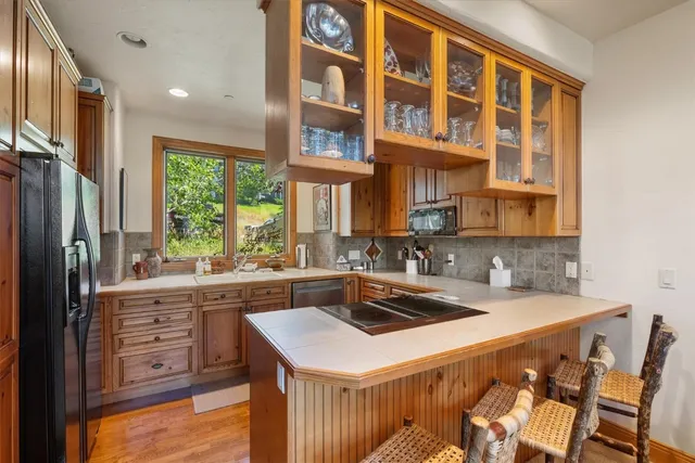 a kitchen with a sink a stove and a refrigerator