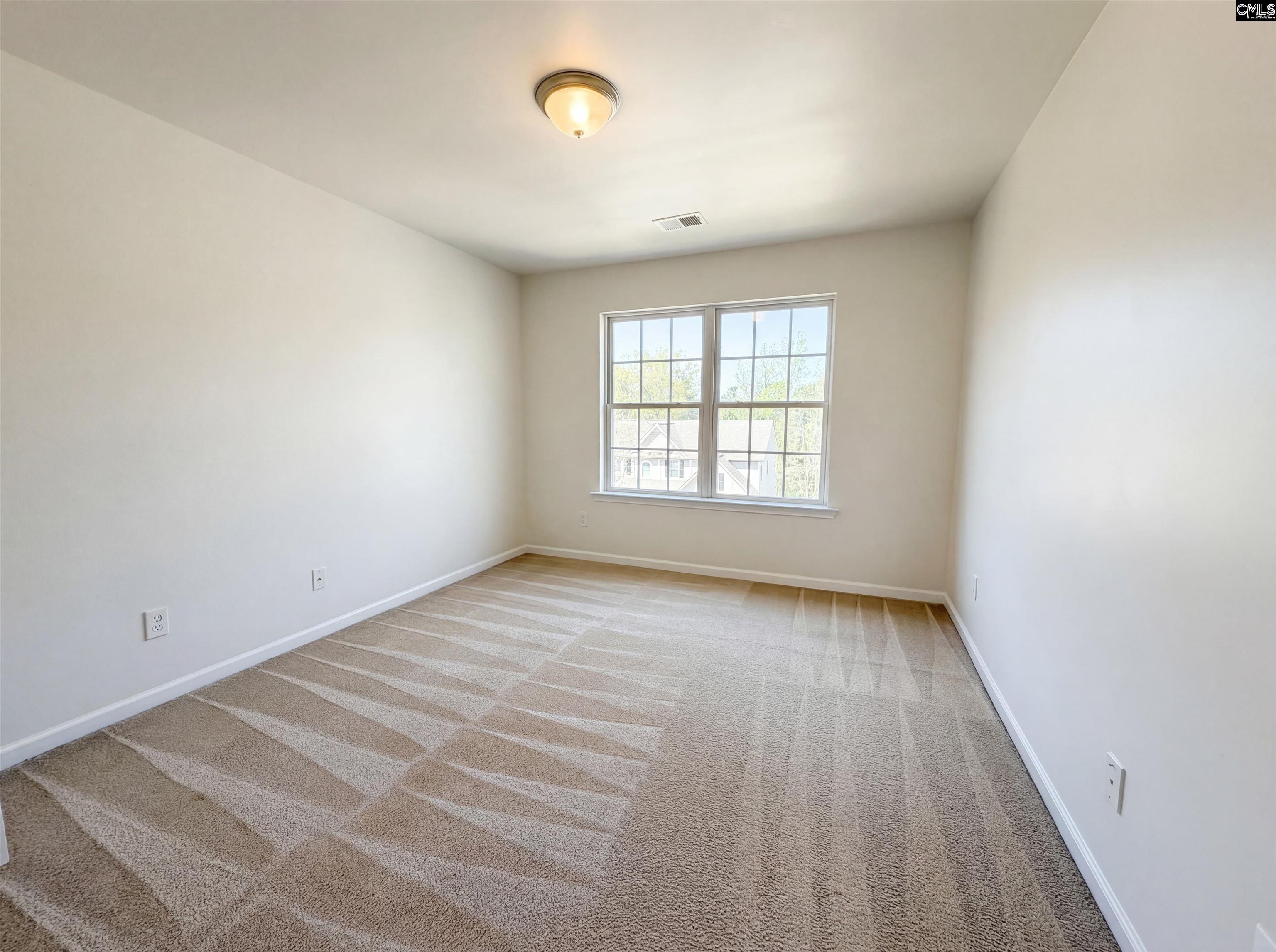 112 Coopers Hawk Circle Irmo, SC 29063 - Photo 24 of 26 an empty room with wooden floor and windows