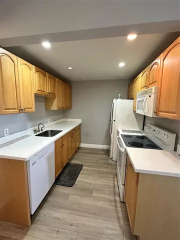a kitchen with a stove sink and a refrigerator