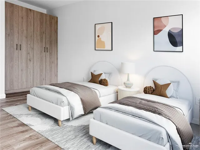 a bedroom with two beds and painting on the wall