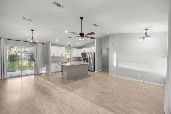 a large kitchen with a refrigerator a sink dishwasher and a view of kitchen