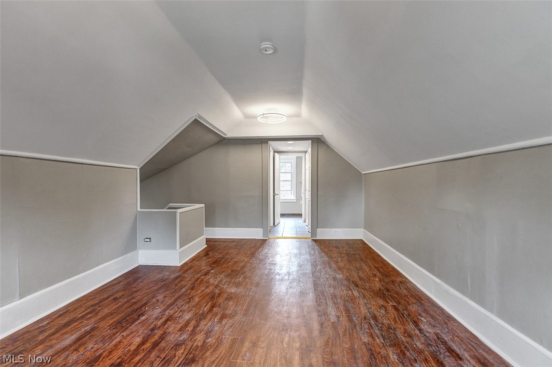 2972 Yorkshire Road Cleveland Heights, OH 44118 - Photo 19 of 44 Spacious upper-level room featuring rich wood-finish flooring, neutral gray walls, bright white trim, and a contemporary ceiling light fixture