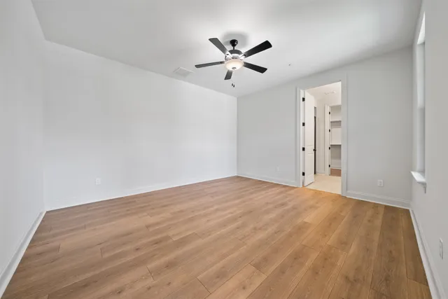 a view of a room with a ceiling fan