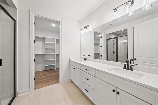 a spacious bathroom with a double vanity sink mirror and double