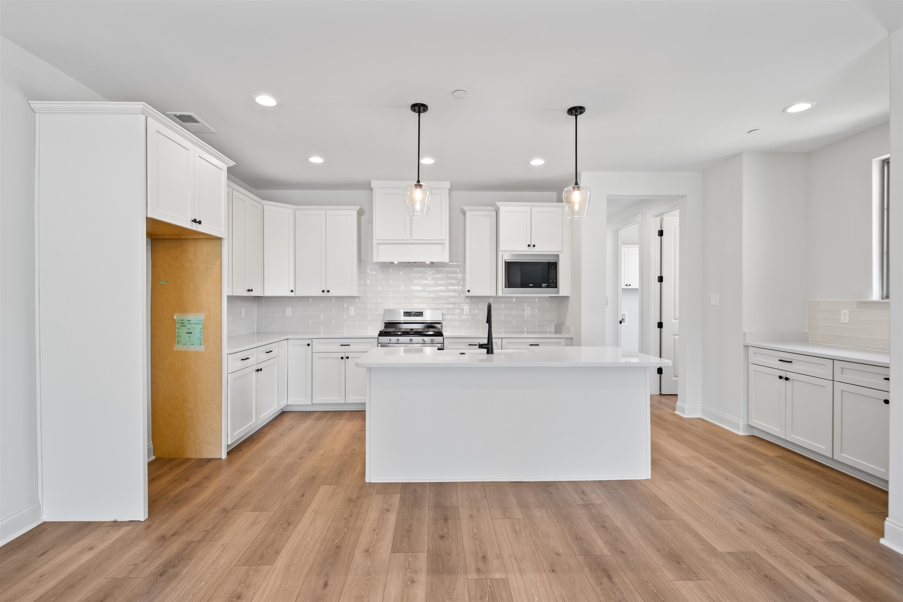 498 Armel Drive Collierville, TN 38017 - Photo 4 of 29 a large kitchen with cabinets wooden floor and stainless steel appliances