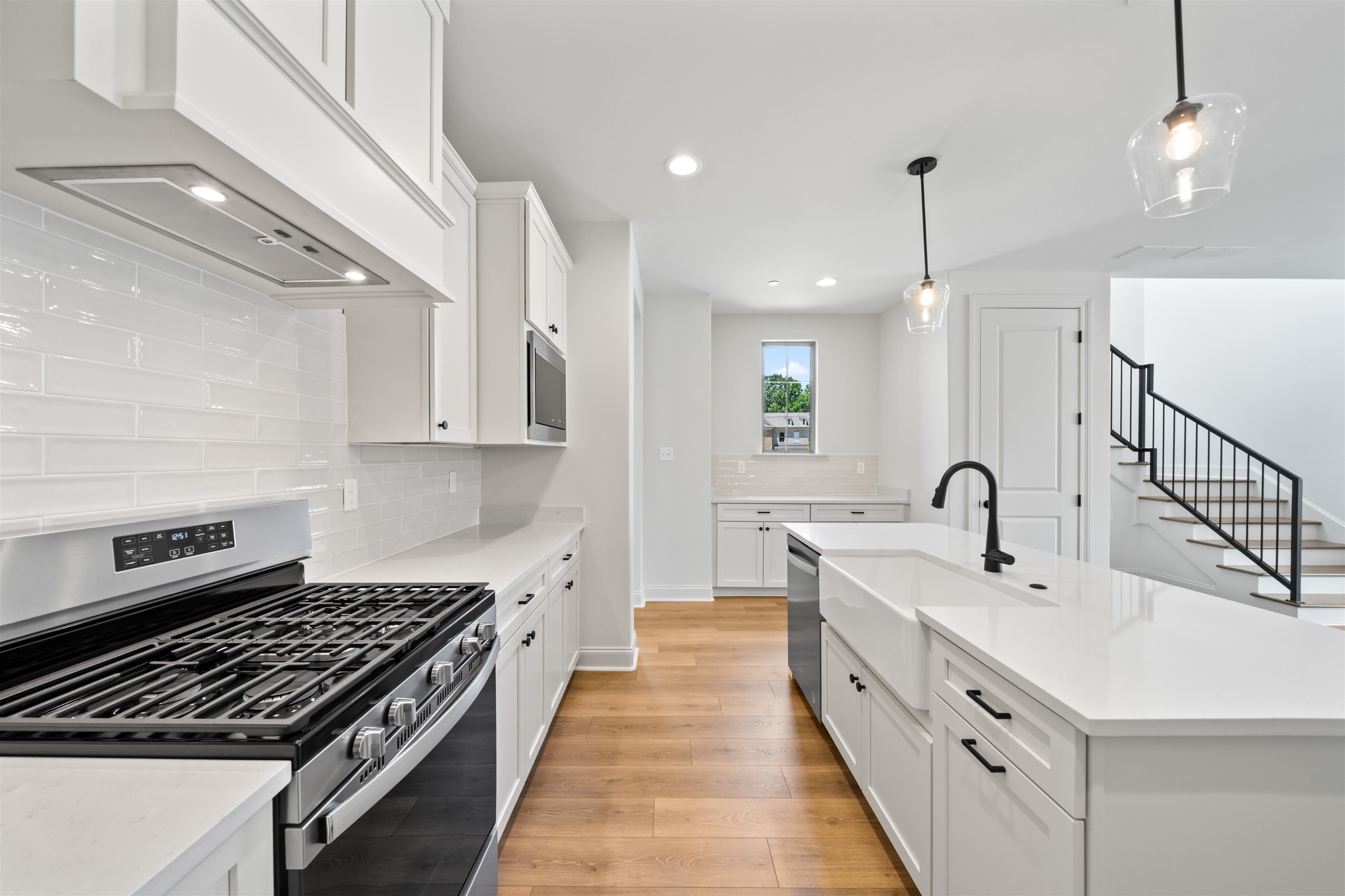 498 Armel Drive Collierville, TN 38017 - Photo 6 of 29 a kitchen with white cabinets stove and sink