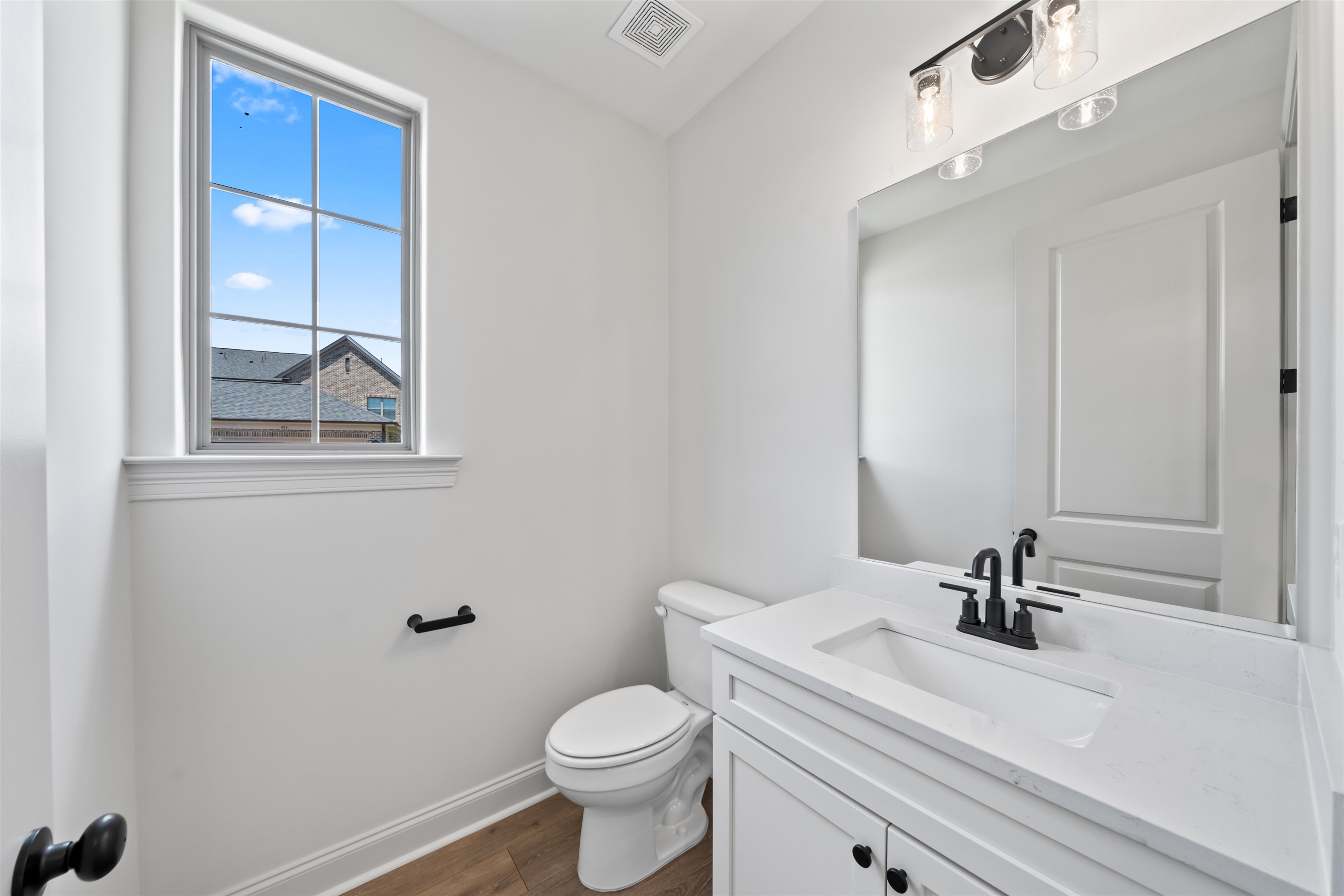 498 Armel Drive Collierville, TN 38017 - Photo 10 of 29 a bathroom with a sink a toilet and a mirror