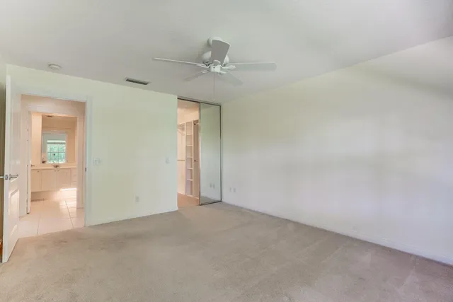 an empty room with fan and entrance
