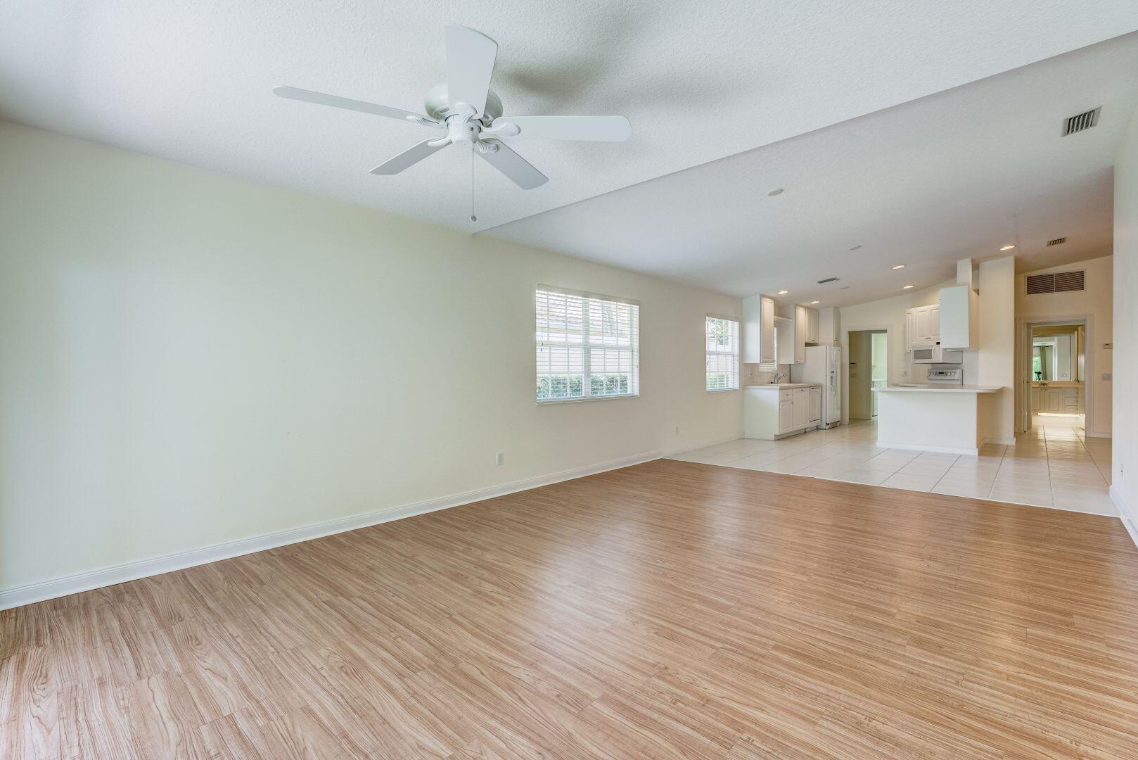 923 Magdalena Road Palm Beach Gardens, FL 33410 - Photo 15 of 47 wooden floor in an empty room with a window