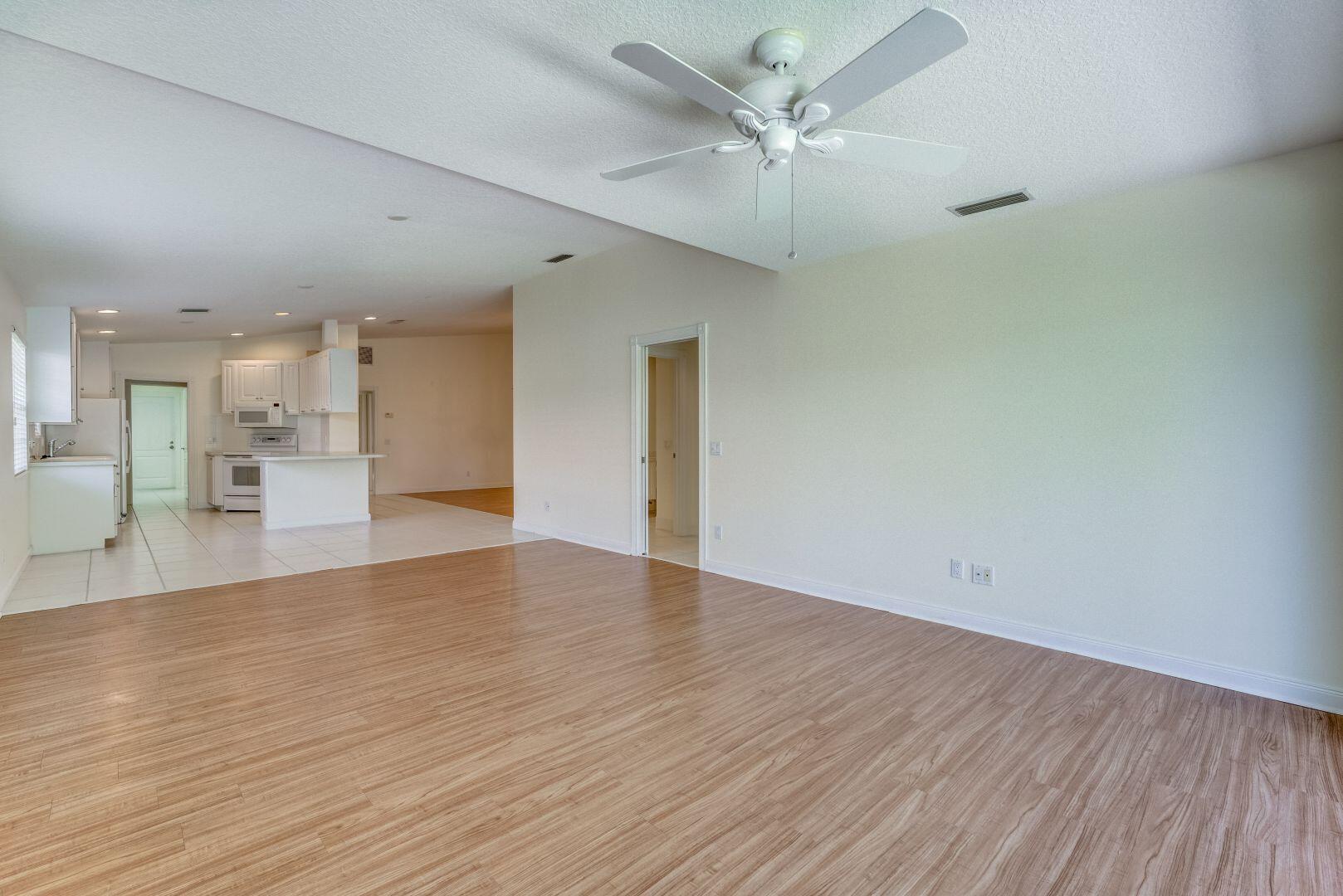 923 Magdalena Road Palm Beach Gardens, FL 33410 - Photo 17 of 47 a view of empty room with wooden floor