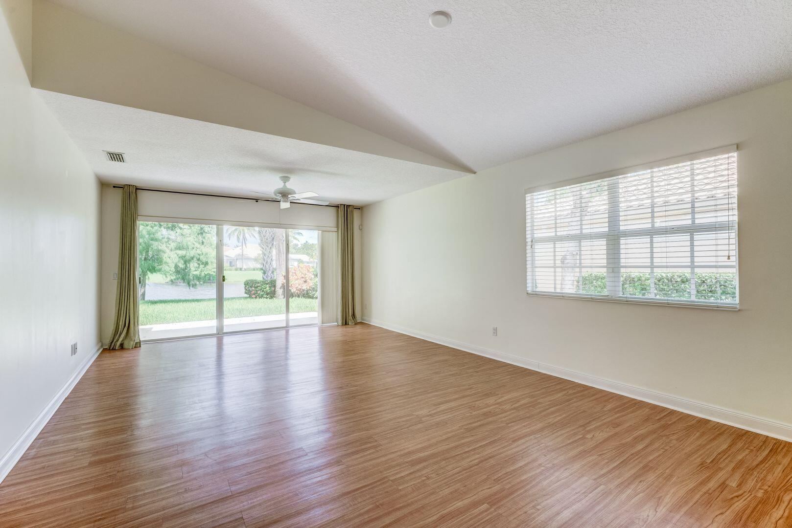 923 Magdalena Road Palm Beach Gardens, FL 33410 - Photo 20 of 47 an empty room with wooden floor and windows