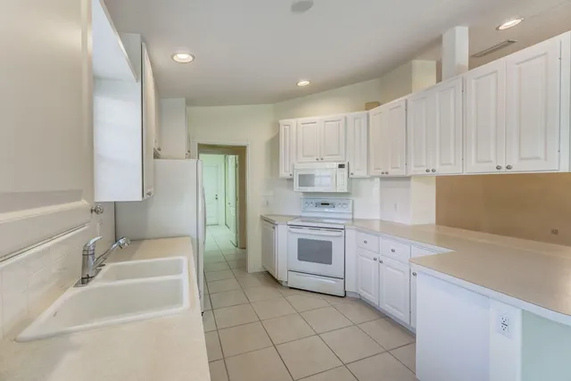 a kitchen with a sink stove and cabinets
