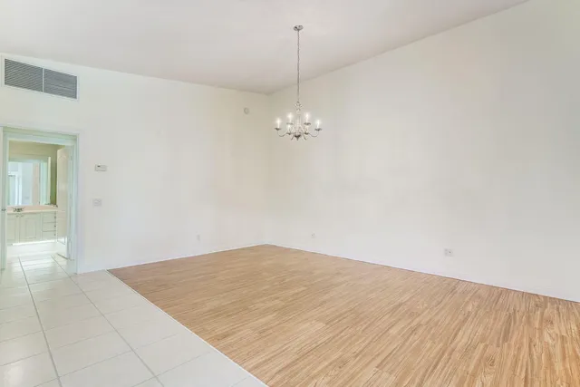 a view of a room with wooden floor and white walls