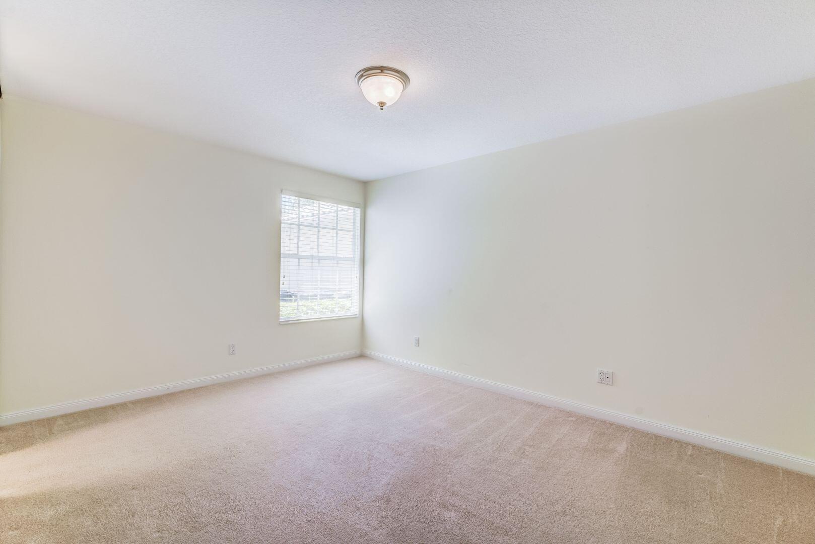 923 Magdalena Road Palm Beach Gardens, FL 33410 - Photo 28 of 47 a view of an empty room with a window