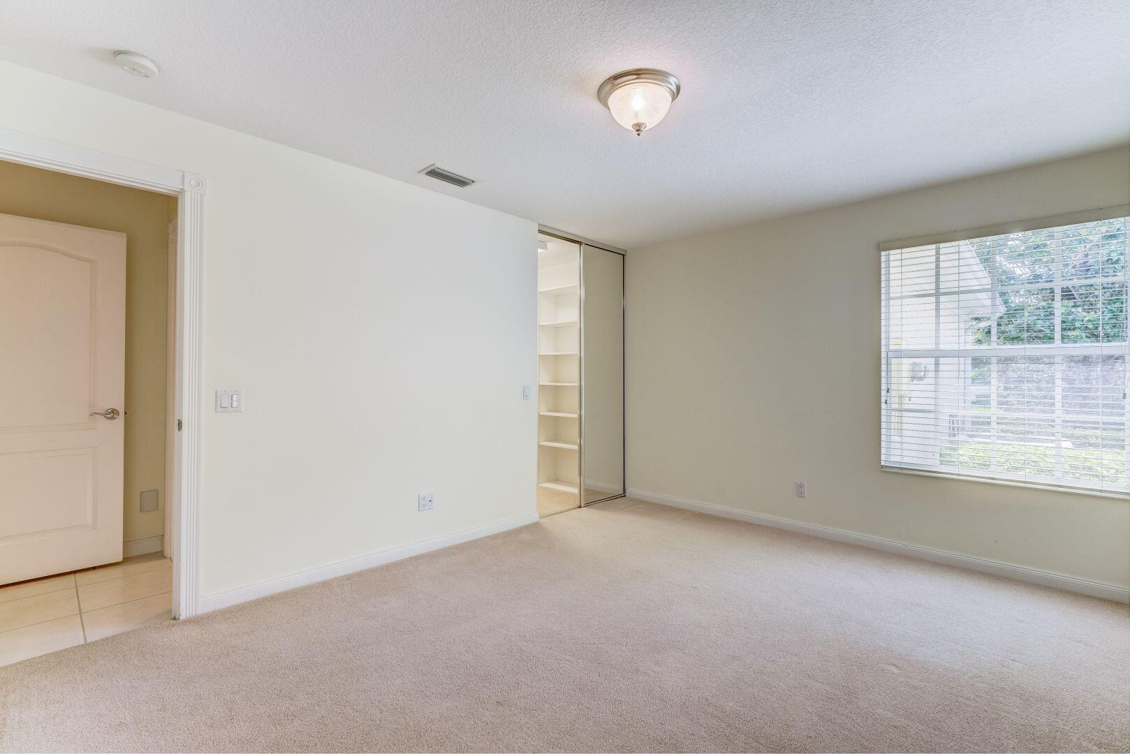923 Magdalena Road Palm Beach Gardens, FL 33410 - Photo 29 of 47 an empty room with a empty space and windows