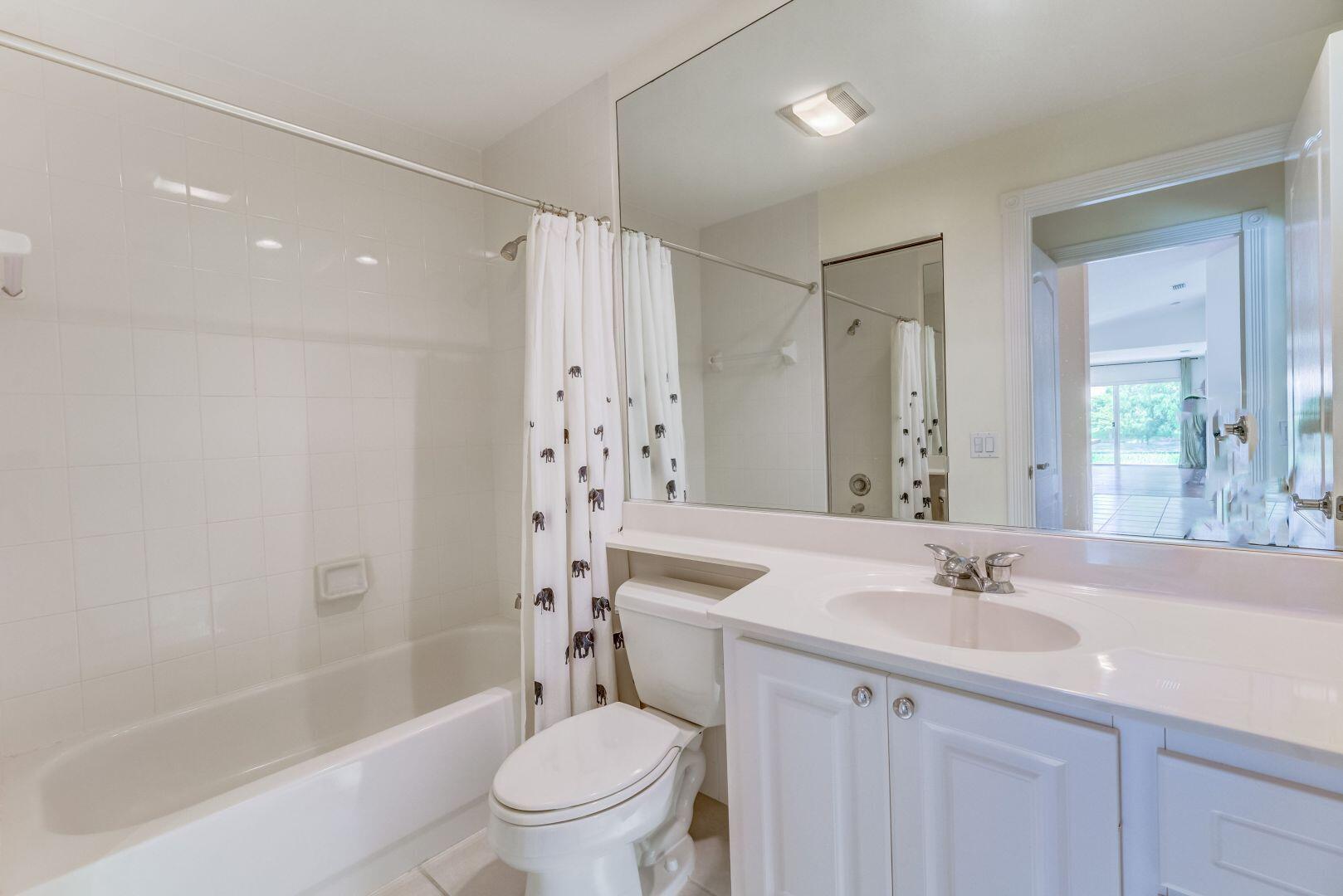 923 Magdalena Road Palm Beach Gardens, FL 33410 - Photo 30 of 47 a bathroom with a sink toilet and shower