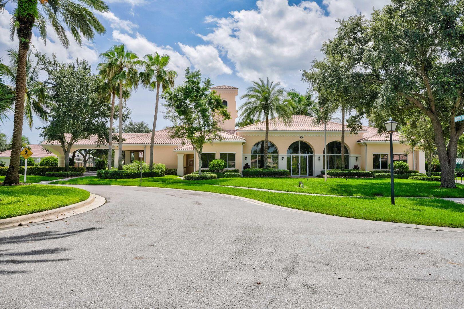 923 Magdalena Road Palm Beach Gardens, FL 33410 - Photo 32 of 47 a view of white house with a big yard and large trees