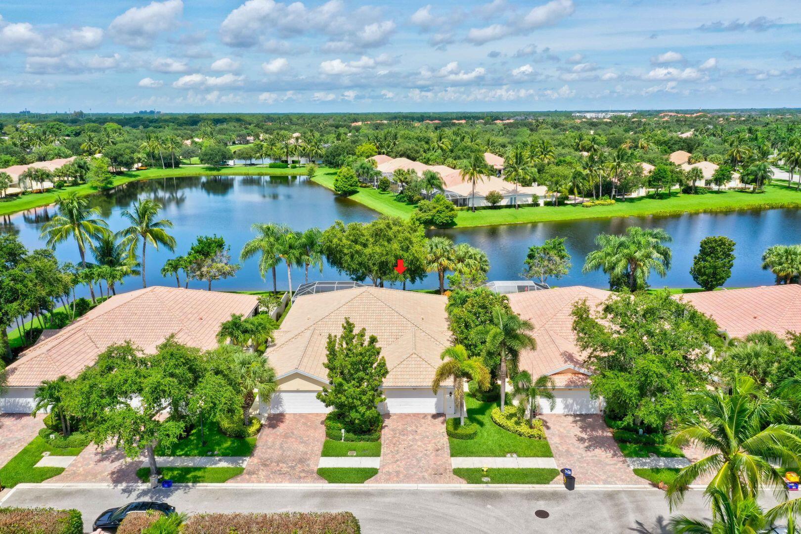 923 Magdalena Road Palm Beach Gardens, FL 33410 - Photo 38 of 47 a view of a lake with a building in the background