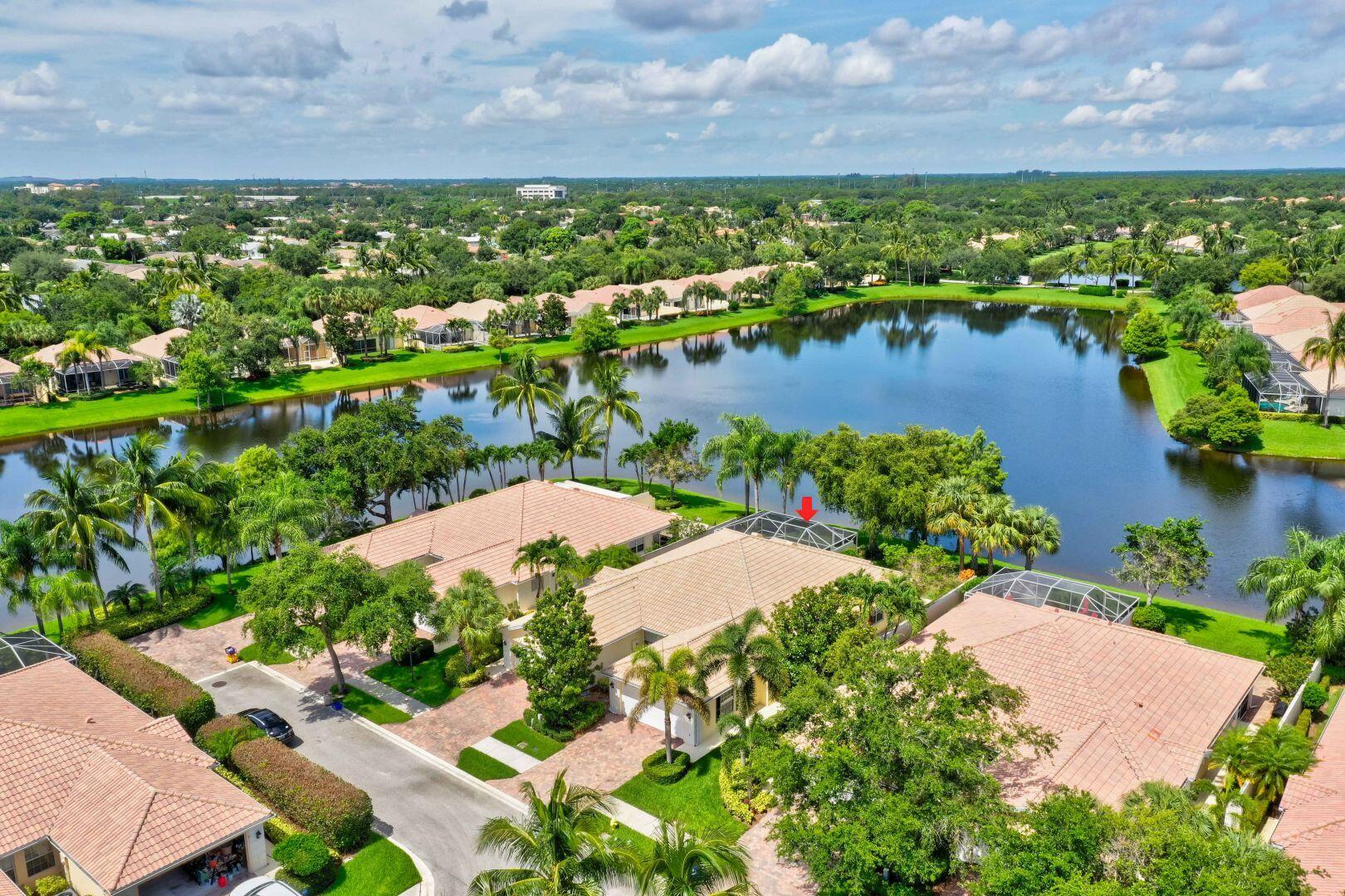923 Magdalena Road Palm Beach Gardens, FL 33410 - Photo 43 of 47 a view of a lake with a building in the background