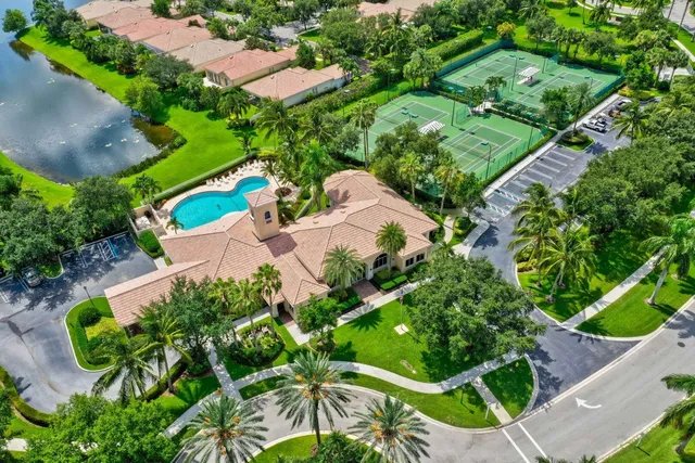 an aerial view of a house with a yard and lake