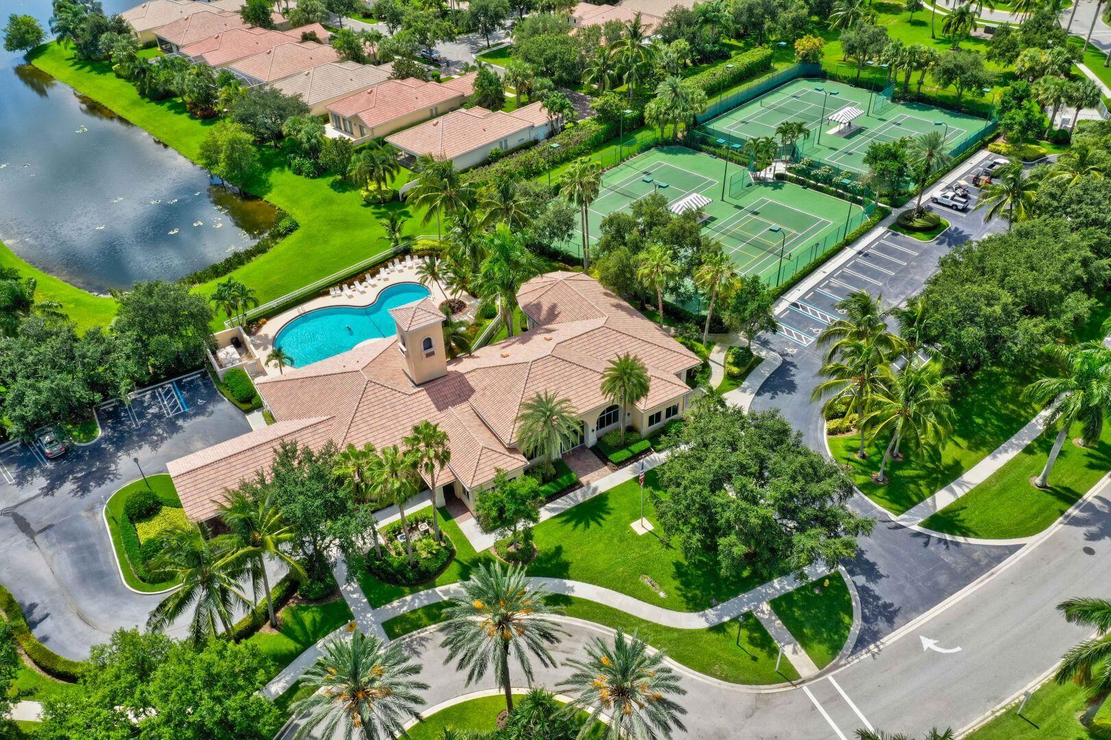 923 Magdalena Road Palm Beach Gardens, FL 33410 - Photo 46 of 47 an aerial view of a house with a yard and lake