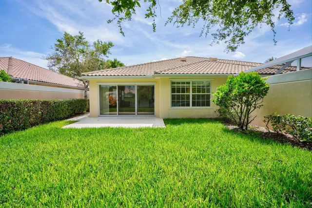 a view of an house with backyard space and garden