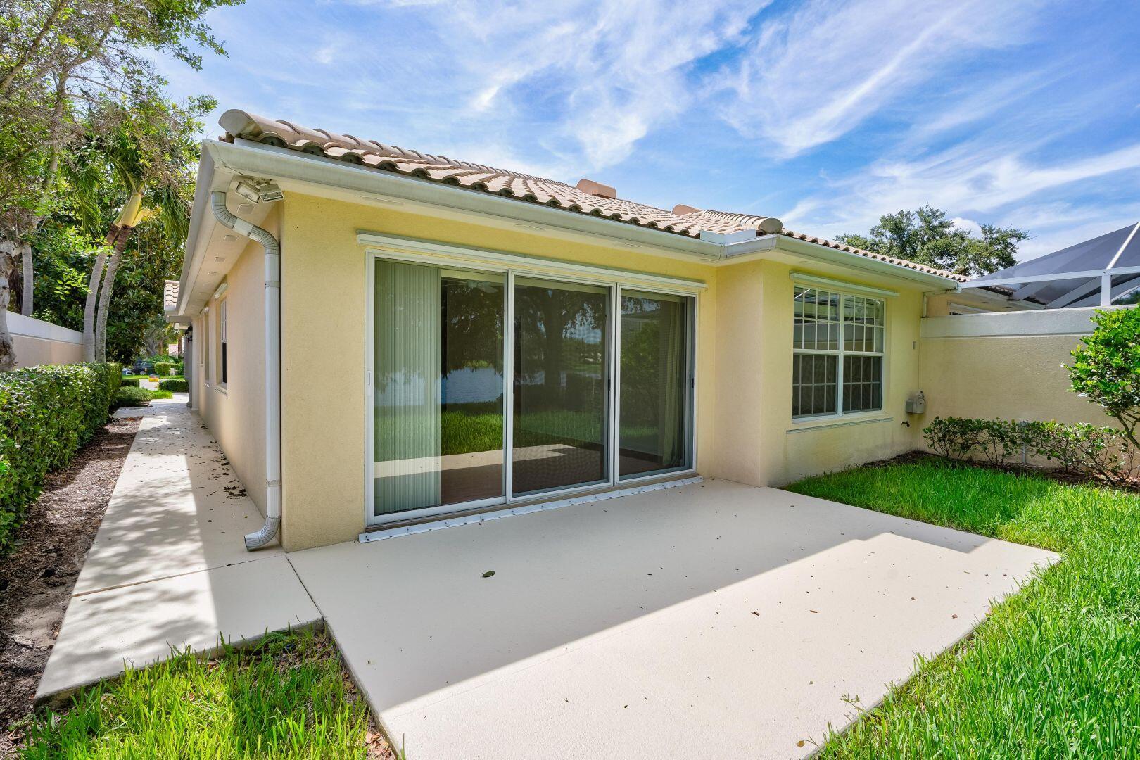 923 Magdalena Road Palm Beach Gardens, FL 33410 - Photo 10 of 47 a view of a house with a porch