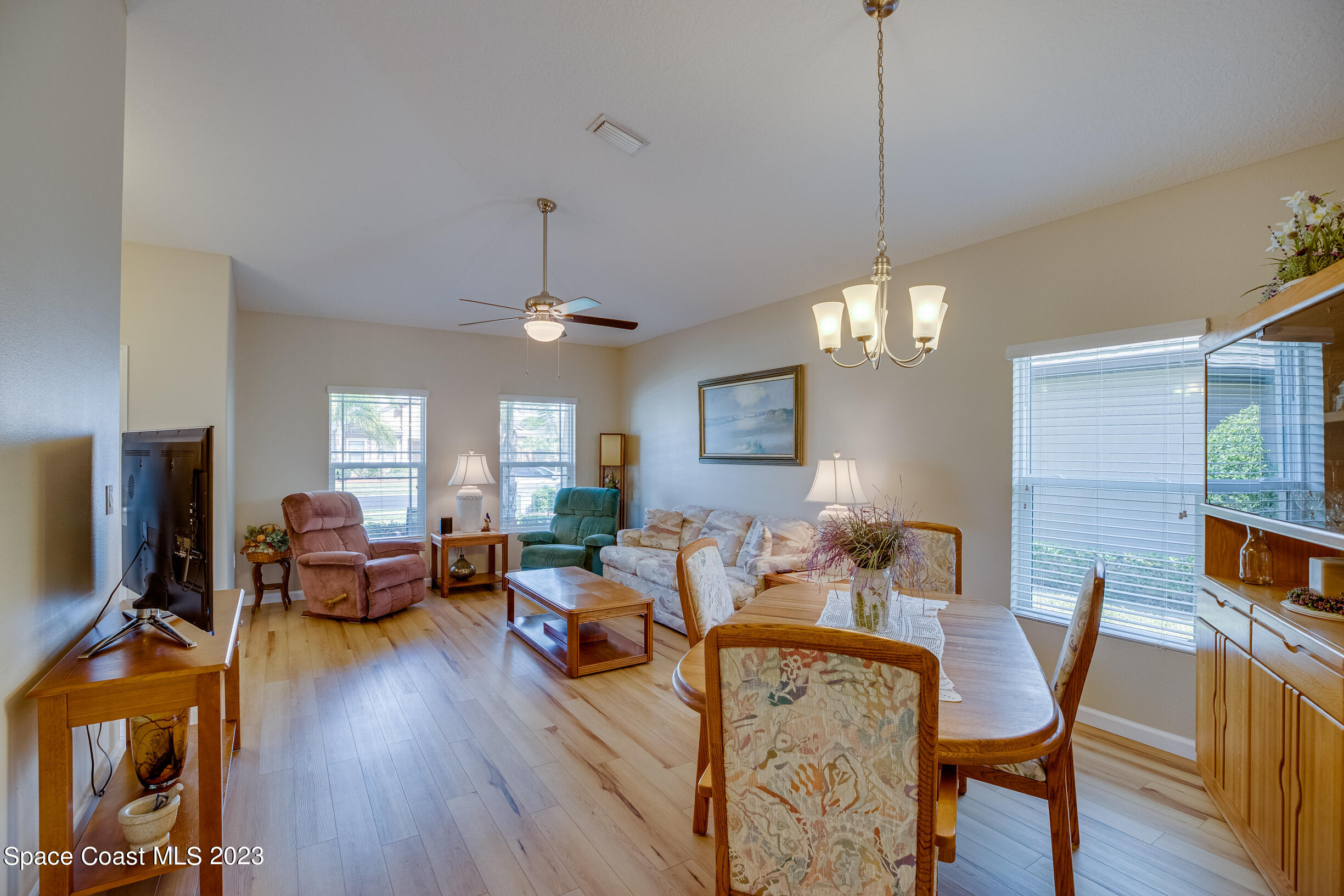 Undisclosed Address Melbourne, FL 32901 - Photo 17 of 53 a view of a dining room with furniture a chandelier and wooden floor