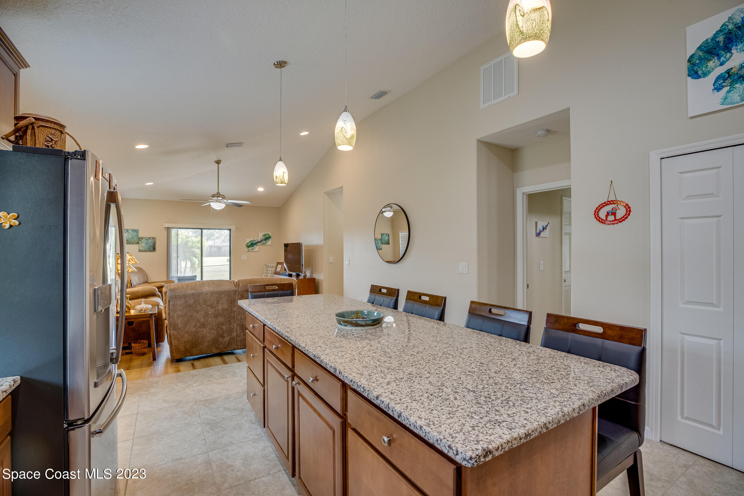 Undisclosed Address Melbourne, FL 32901 - Photo 24 of 53 a kitchen with a table chairs and refrigerator