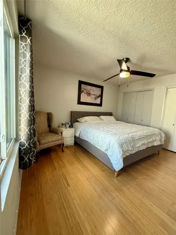 a spacious bedroom with a bed and a window