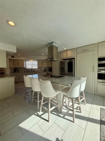 a kitchen with a stove a sink and a microwave