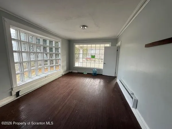 wooden floor in an empty room with a window