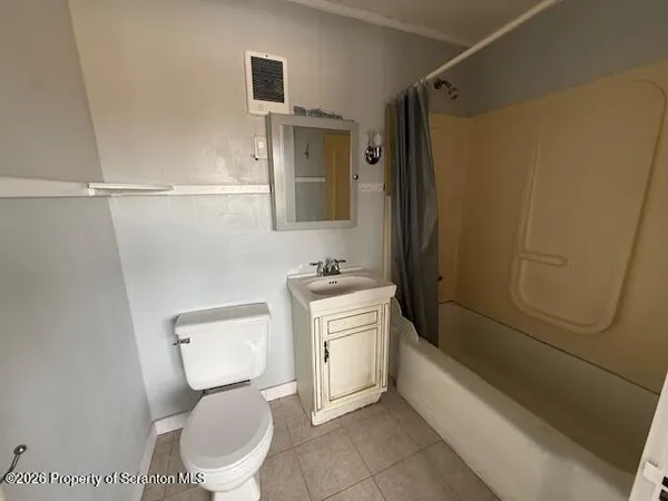 a bathroom with a toilet sink and shower