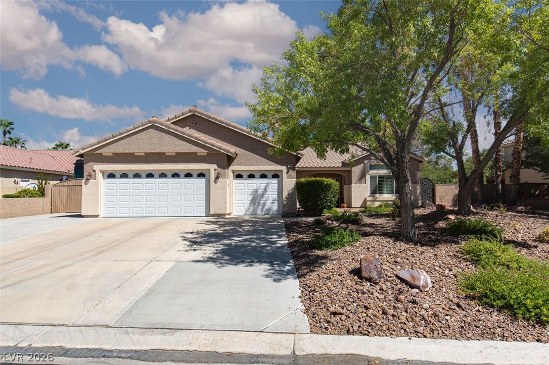 4670 Los Rancheros Avenue Las Vegas, NV 89129 - Photo 56 of 57 Desert landscaping and mature trees frame the facade of this stucco home.